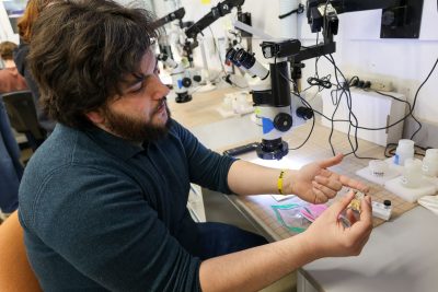Jack Stack holds a small specimen on his finger. 