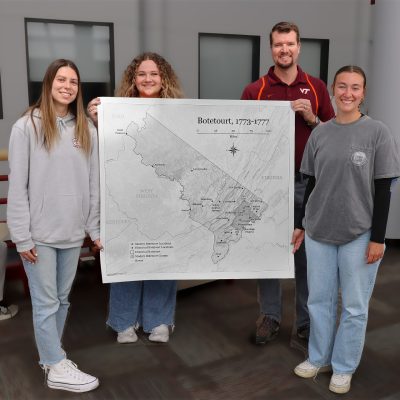 Hannah Crook (far left), Emma Dilic (middle left), and Sarah Cohoon (far right) are undergraduate teaching assistants in Senior Instructor Stewart Scales' (middle right) cartography class. When the Botetourt County Historical Society needed a map of the county in 1775, the TAs were tasked with its creation. It was presented to the society in March.