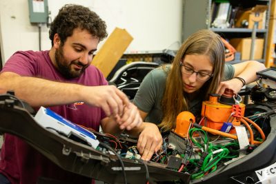 Professor and students working on research project