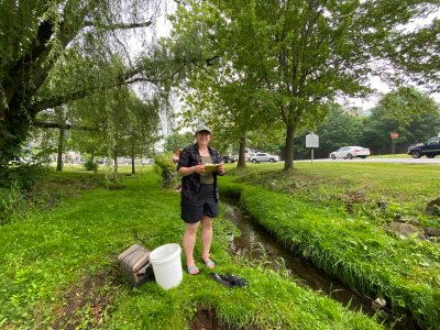 The photo shows Cleo Orlando by Stroubles stream near the Duck Pond on the campus of Virginia Tech.